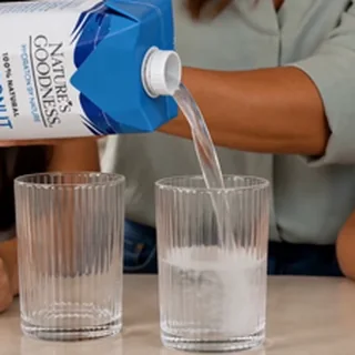 Coconut water being poured into a glass