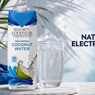 A family sharing coconut water at a kitchen counter